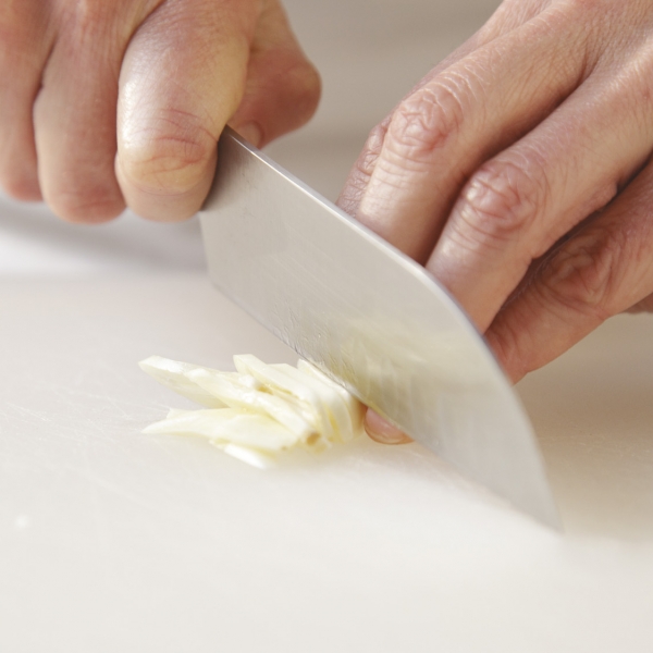 For a very even mince, cut the clove into thin slices first.
